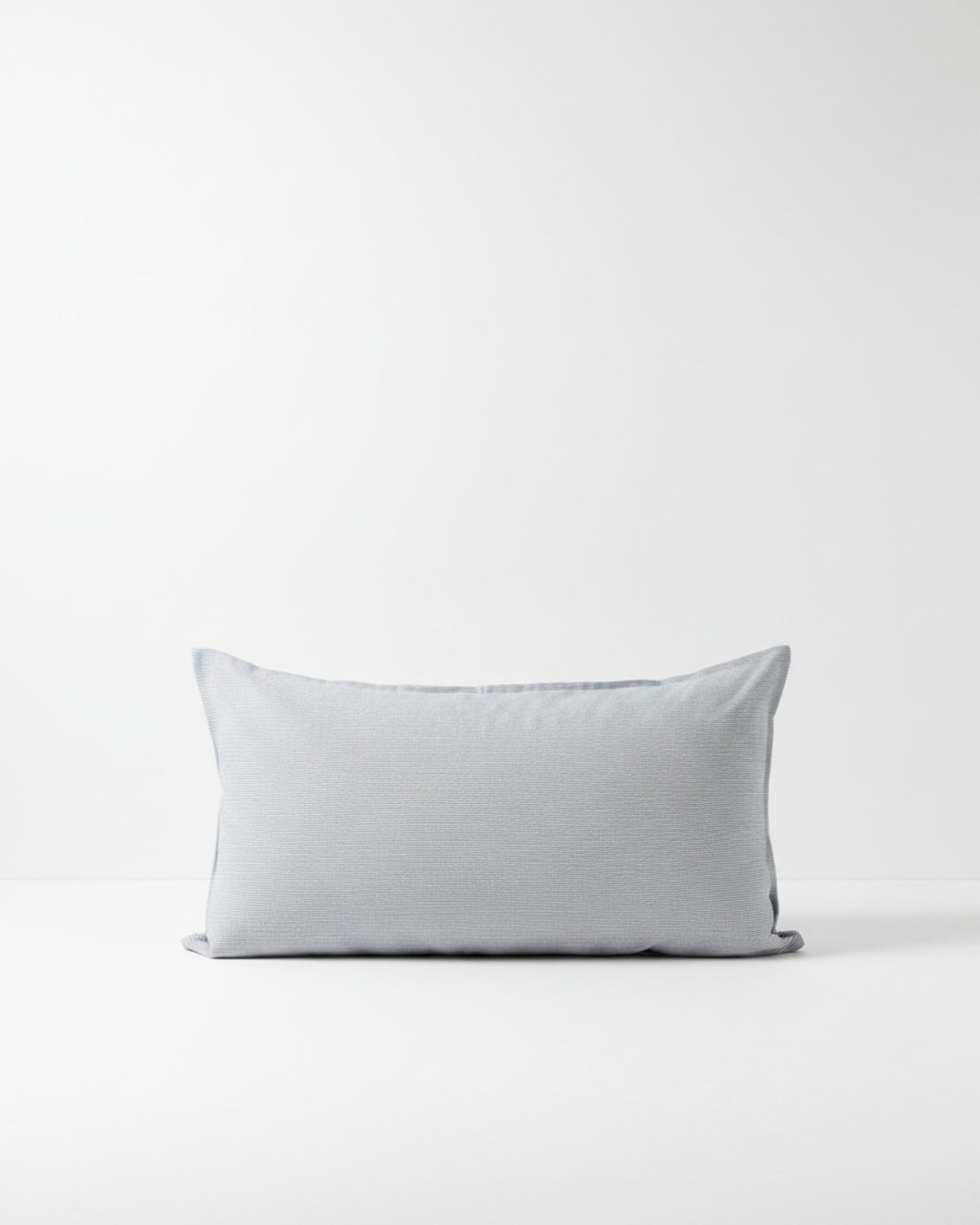 Funda de cojín Kankla de algodón azul con diseño de líneas finas y cierre invisible, fabricada en Chile.